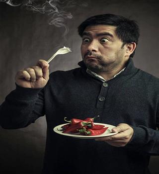 Why do we feel spicy after eating chillies?