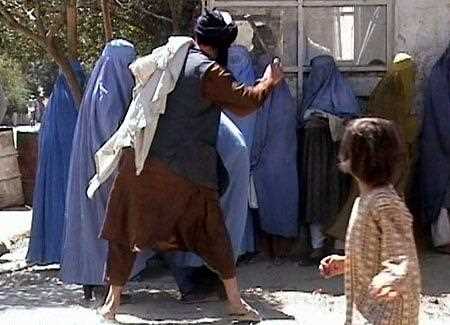 Taliban official is seen beating female students in a video.